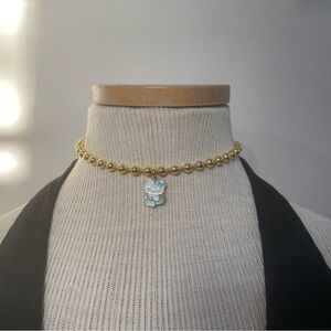 Gold Beaded Necklace with Blue Charm